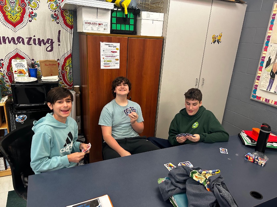three boys play Uno in Amber Chandler's classroom